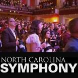 Photo of people holding candles in Symphony audience