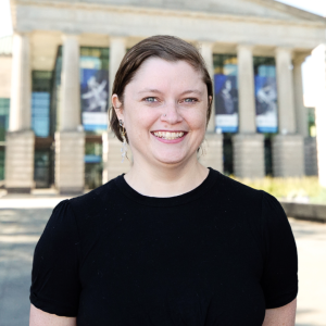 Kristen Butler headshot with Martin Marietta Center for the Performing Arts façade in background